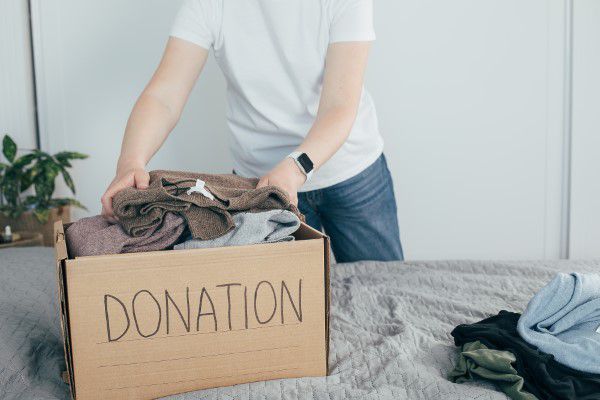 Man preparing old clothes to donate