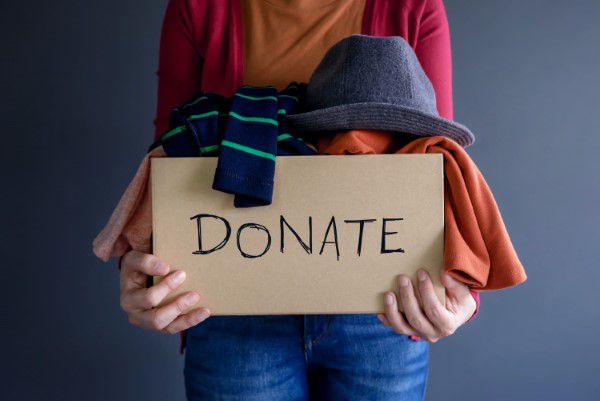 Woman holding a bag of clothes ready for donating