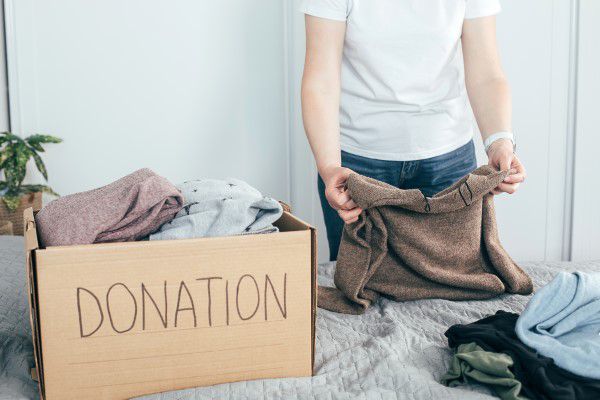 Woman preparing clothes for donation